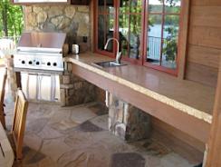 Lovely outdoor patio with a granite counter top and sink. 